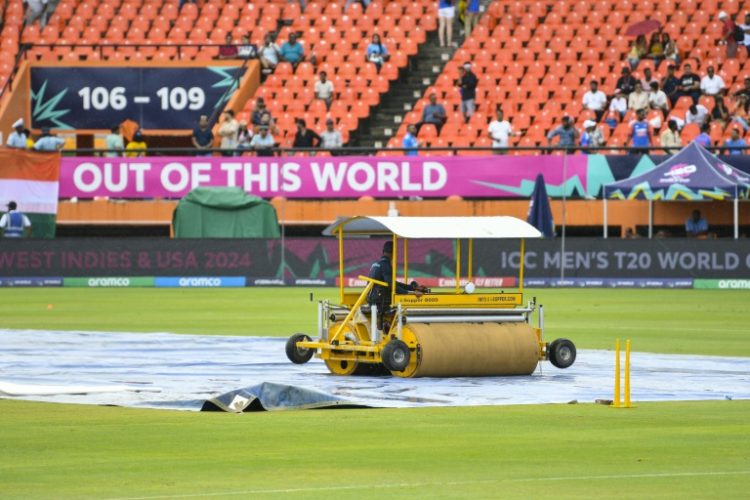 Delayed start: Groundstaff mop up after rain delayed the start of the T20 World Cup semi-final between India and England at the Providence Stadium, Guyana. ©AFP