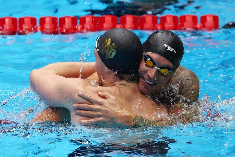 Caeleb Dressel and Chris Guiliano share a hug after finishing one-two in the 50m freestyle at the US Olympic swimming trials. ©AFP