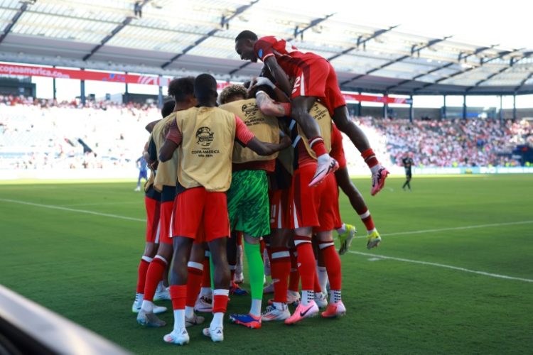 Canada goalscorer Jonathan David is mobbed by team-mates after scoring the only goal in a 1-0 win over Peru at the Copa America on Tuesday. ©AFP