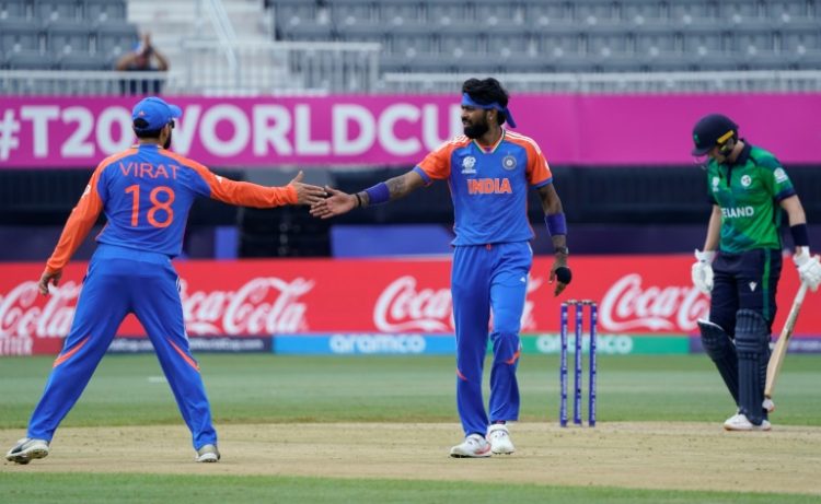 India's Hardik Pandya (C) celebrates with Virat Kohli (L) after taking a wicket in a T20 World Cup match against Ireland in New York. ©AFP