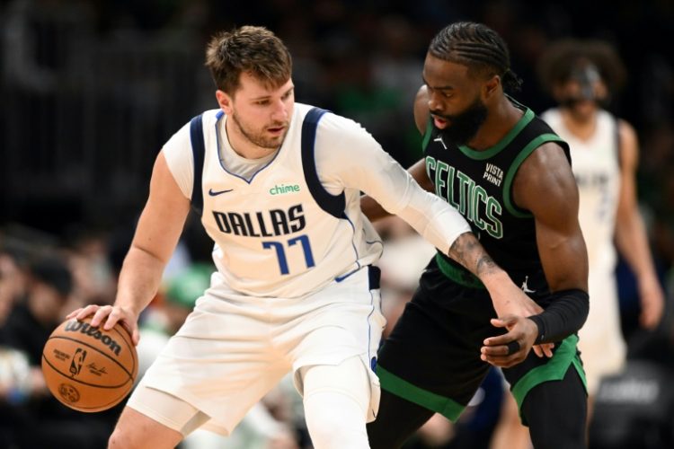 NBA scoring champion Luka Doncic, left, of the Dallas Mavericks goes against Boston's Jaylen Brown, right, in a regular-season matchup that previewed Thursday's opening game of the NBA Finals. ©AFP