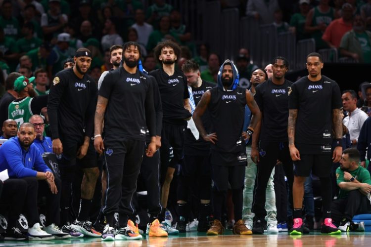 Kyrie Irving and Dallas Mavericks teammates watch from the bench in the final minutes of their game-one loss to Boston in the NBA Finals. ©AFP