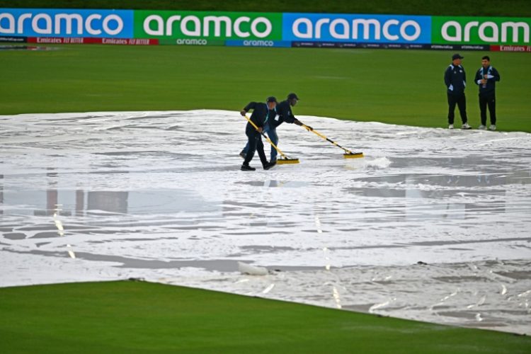 Match officials wipe water from the pitch but the ICC men's Twenty20 World Cup 2024 group D cricket match between Sri Lanka and Nepal at Central Broward Parkwas ultimately called off. ©AFP