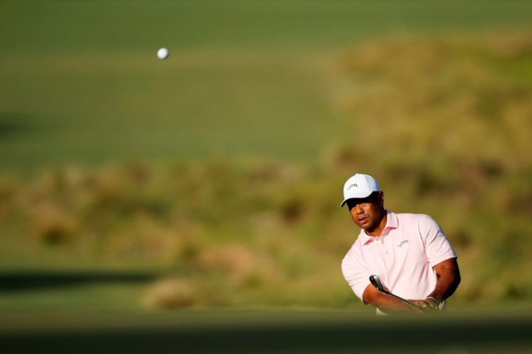 Tiger Woods, chiping onto the first green during a US Open practice round, says merger talks between the PGA Tour and Saudi backers of LIV Golf are nearing an endgame after a productive meeting. ©AFP