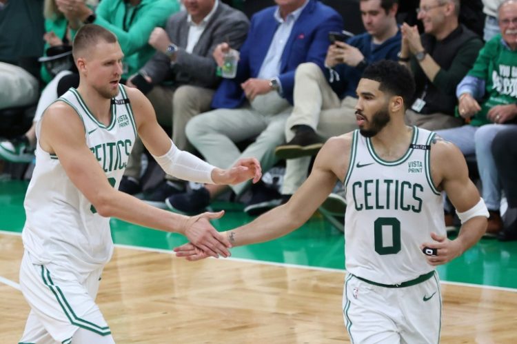 Kristaps Porzingis high fives Boston teammate Jayson Tatum during the Celtics' victory over Dallas in game one of the NBA Finals. ©AFP