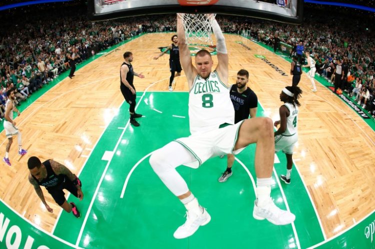 Boston's Kristaps Porzingis dunks in the first quarter of the Celtics' victory over Dallas in game one of the NBA Finals. ©AFP