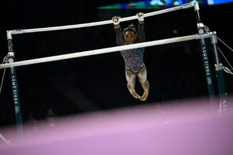 Four-time Olympic gold medallist Simone Biles trains on uneven bars in the run-up to the Paris Games. ©AFP