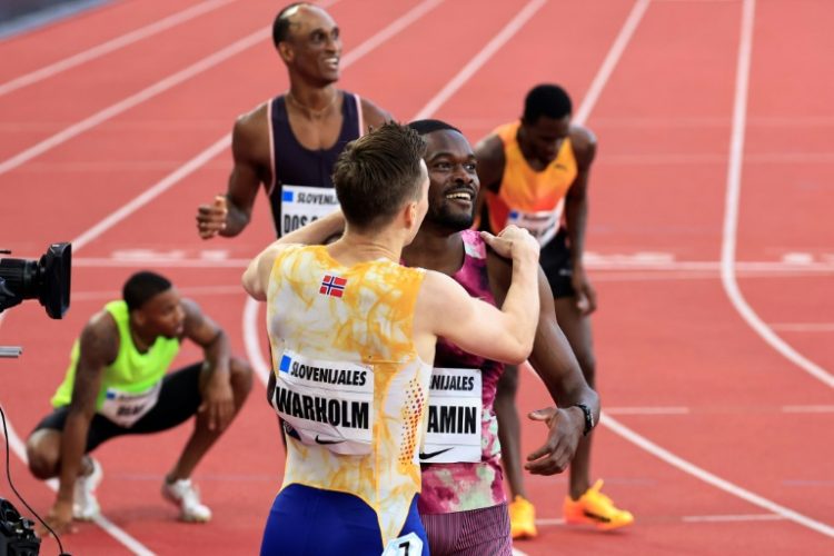 Norway's Karsten Warholm and American Rai Benjamin (C) react after the men's 400m hurdles. ©AFP