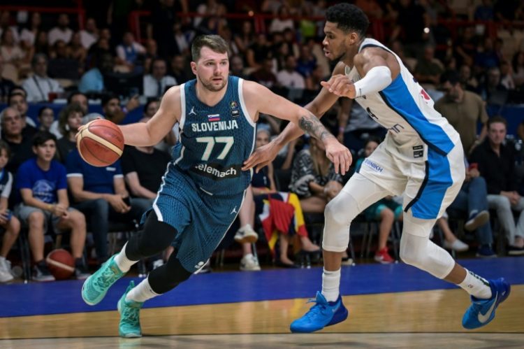 Slovenia’s Luka Doncic (L) is marked by Greece’s Giannis Antentokoumpo during the 2024 FIBA Olympic Qualifying Tournament semi-final basketball match in Piraeus. ©AFP