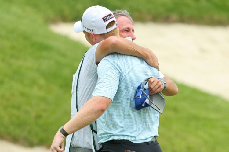 Hayden Springer (right) celebrates with his caddie after a last-hole birdie saw him complete a 59 at the John Deere Classic in Illinois on Thursday. ©AFP