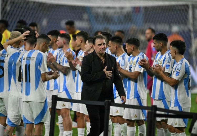 Colombia's Argentine coach Nestor Lorenzo walks past Argentina's players after the Copa America final on Sunday.. ©AFP