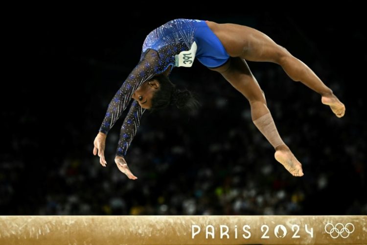 Biles shook off a sub-par uneven bars routine to edge Rebeca Andrade for all-around gold on Thursday  . ©AFP