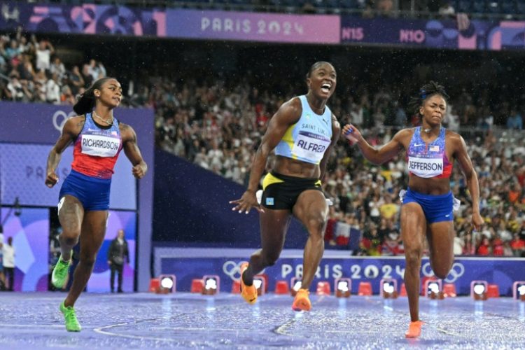 Saint Lucia's Julien Alfred roars with delight after winning the women's Olympic 100m final. ©AFP