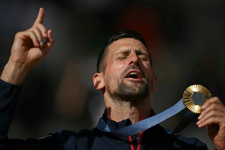 Golden moment: Novak Djokovic celebrates clinching the Olympic title. ©AFP