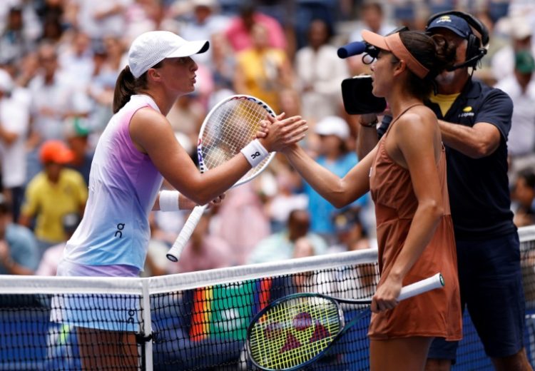 World number one Iga Swiatek shakes hands with Ena Shibahara after a resounding victory over the Japanese player in the US Open second round. ©AFP