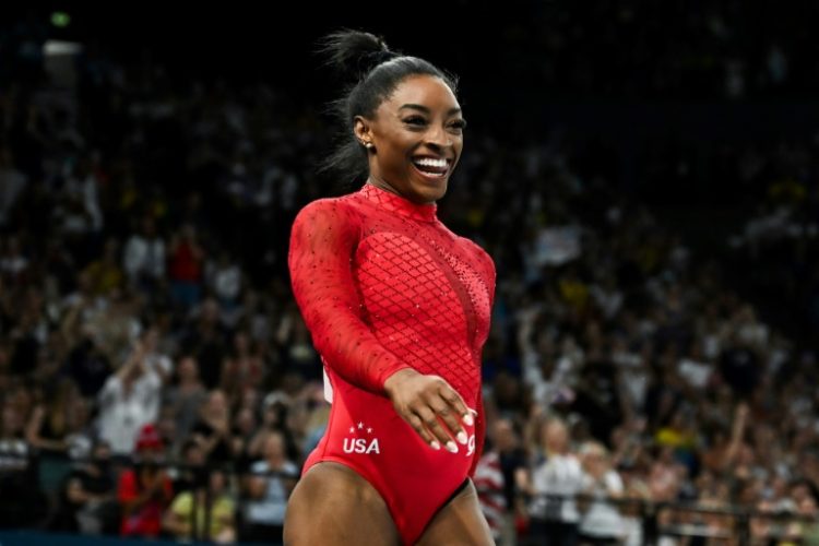 Simone Biles reacts after wrapping up women's gymnastics vault gold, her third gold medal of the Paris Olympics. ©AFP