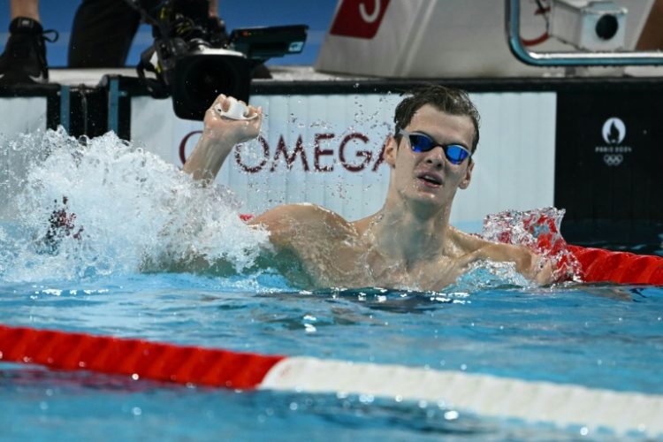 Hungary's Hubert Kos celebrates after winning  the final of the men's 200m backstroke. ©AFP