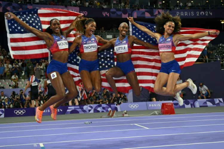 The victorious US 4x400 women's relay squad celebrate an eighth consecutive Olympic gold in the event. ©AFP