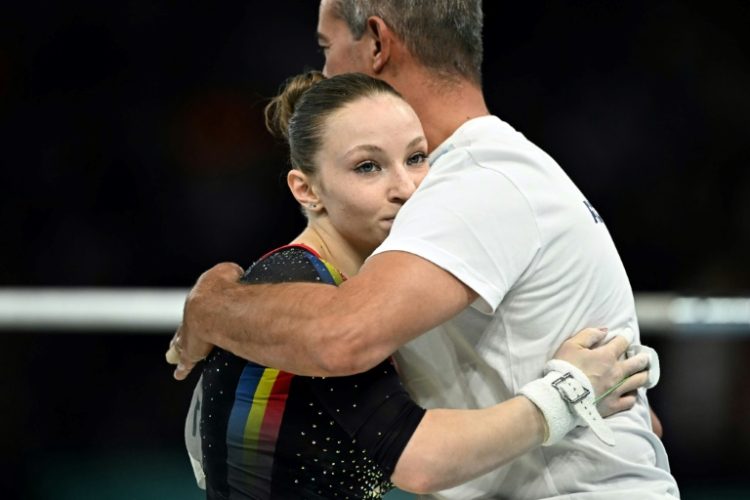 Romanian gymnast Ana Barbosu with her coach during the Paris Olympics. ©AFP