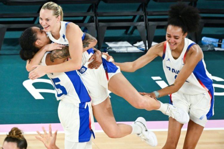 France's Gabby Williams and Marine Johannes celebrate their victory over Belgium in the Olympic women's basketball semi-finals. ©AFP