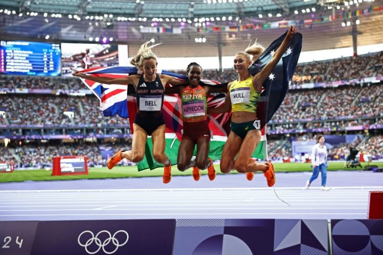 Jump for joy: 1,500m gold medallist Faith Kipyegon with bronze medallist Britain's Georgia Bell (L) and silver medallist Australia's Jessica Hull . ©AFP