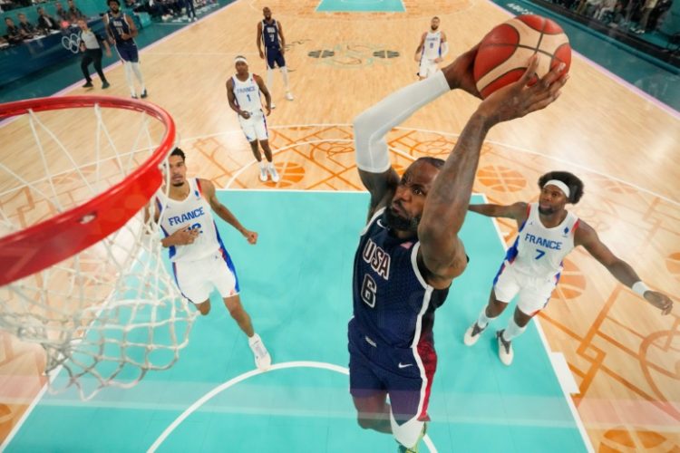 LeBron James dunks as the USA take on France for the men's basketball gold. ©AFP