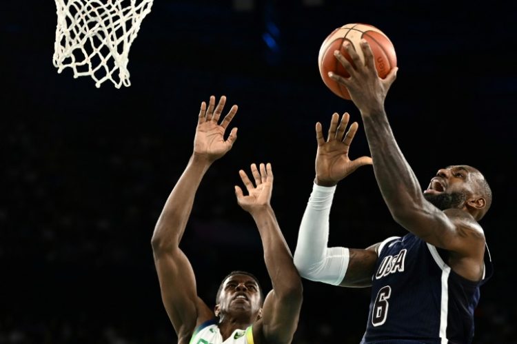 LeBron James of the United States drives to the basket against Georginho De Paula in the US victory over Brazil in the Olympic men's basketball quarter-finals. ©AFP