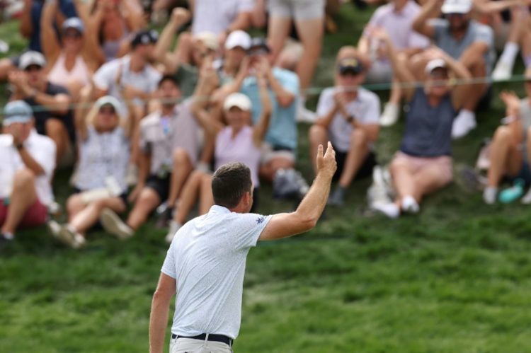 Leader Keegan Bradley acknowledges the crowd after making birdie on the 18th green during the third round of the BMW Championship. ©AFP