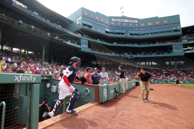 Danny Jansen takes the field for Boston against Toronto on Monday, becoming the first player in baseball history to represent both teams in the same game. ©AFP