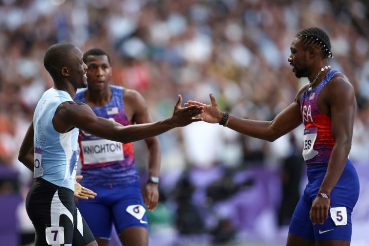 Noah Lyles congratulates Letsile Tebogo after the Botswanan denied him an Olympic sprint double. ©AFP