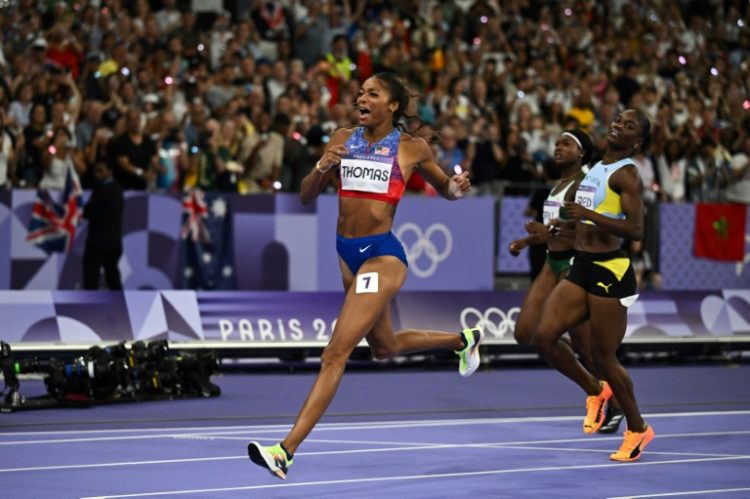 Gabby Thomas celebrates as she crosses the finish line to win women's Olympic 200m gold. ©AFP