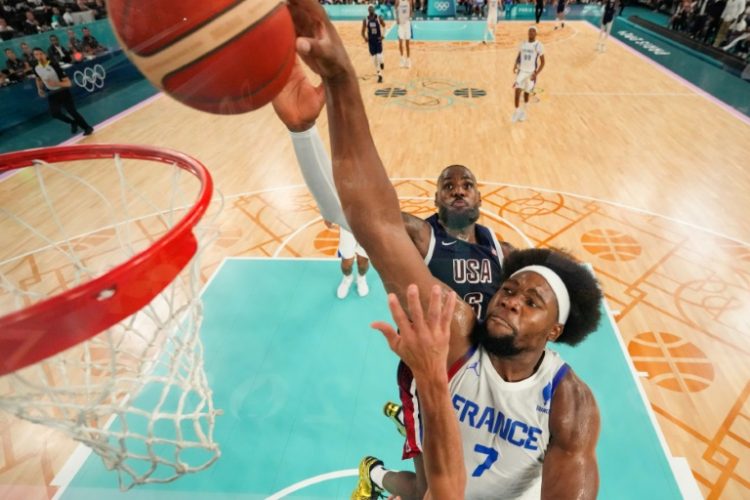 France's Guerschon Yabusele, shown making a basket at the Paris Olympics final, has reportedly agreed to terms to sign with the NBA's Philadelphia 76ers. ©AFP