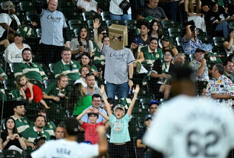 A Chicago White Sox fan wears a paper bag over his head while watching his team, on pace for the losingest season in Major League Baseball history. ©AFP