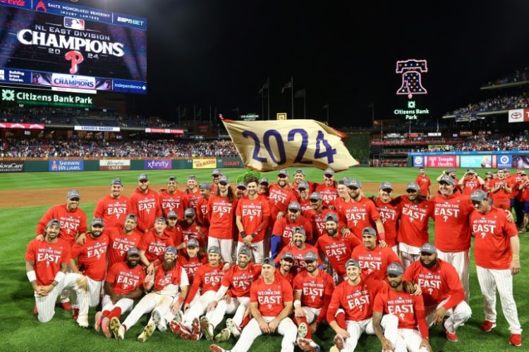 The Philadelphia Phillies celebrate after clinching the NL East title for the first time in 13 years. ©AFP