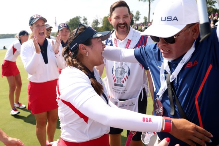 American Lilia Vu celebrates with the US team after scoring the deciding half-point to win the Solheim Cup. ©AFP