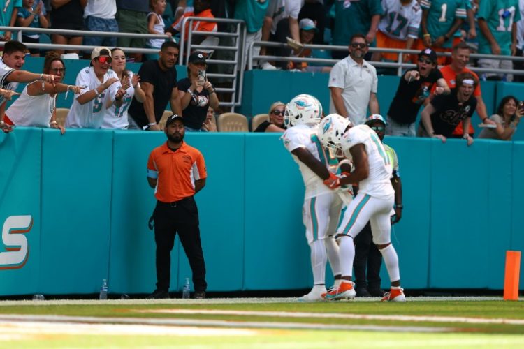 Tyreek Hill celebrates a touchdown by pretending to be handcuffed in Miami's 17-14 win over Jacksonville . ©AFP