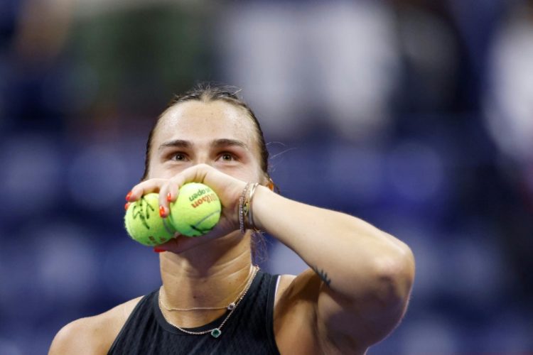 Crowd favourite: Aryna Sabalenka prepares to throw signed tennis balls to fans after defeatng Zheng Qinwen . ©AFP