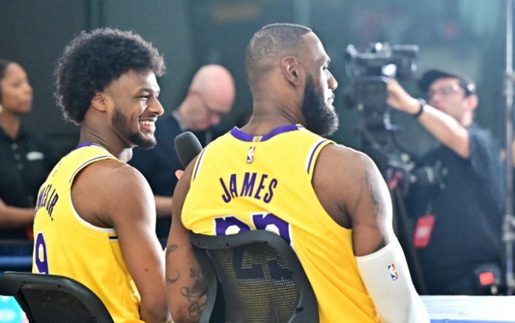 LeBron James (right) gives a television interview alongside son Bronny (left) at the Los Angeles Lakers media day on Monday. ©AFP