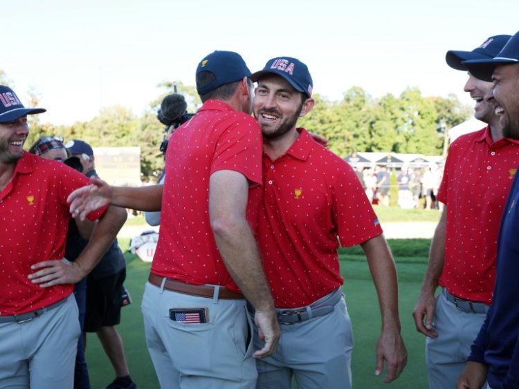 Patrick Cantlay, right center, chest bumps Keegan Bradley as the United States celebrates beating the Internationals to win a 10th consecutive Presidents Cup. ©AFP