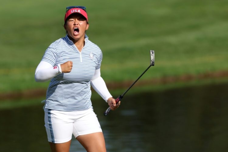 Megan Khang of the United States reacts to making her eagle putt on the 14th hole on the way to a match win that helped the US women seize the lead after Saturday's matches. ©AFP