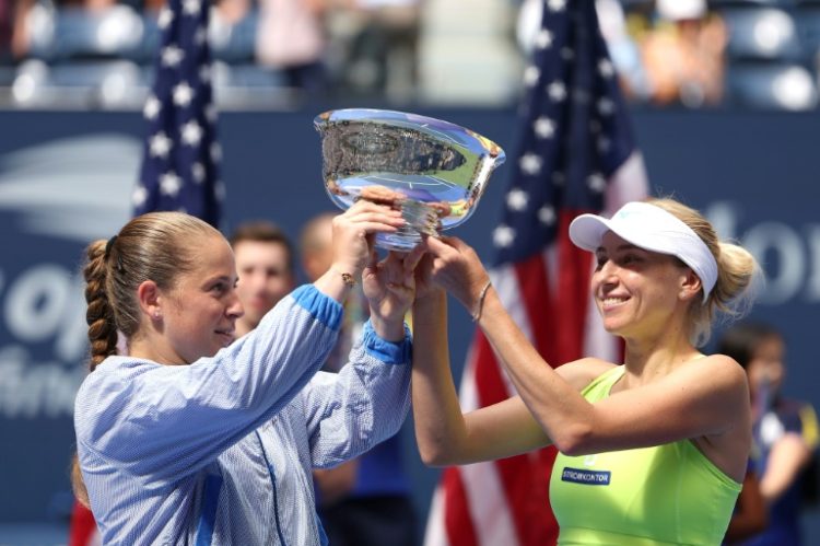 Champions: Bride-to-be Lyudmyla Kichenok (R) with Jelena Ostapenko pose with their trophy . ©AFP