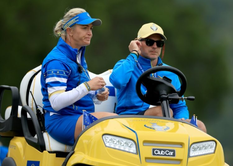 European captain Suzann Pettersen of Norway, left, watches from a golf cart during the first day of the Solheim Cup. ©AFP