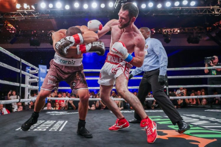 IBF super welterweight world champion Bakhram Murtazaliev knocks down Tim Tszyu on the way to a third-round technical knockout in their world title bout. ©AFP