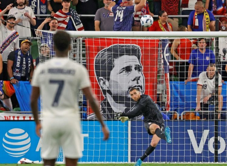 USA goalkeeper Matt Turner clears the ball in front of a banner of head coach Mauricio Pochettino. ©AFP