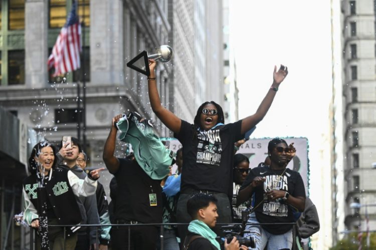 A convoy of floats and open-top buses processed up Manhattan's 'Canyon of Heroes' to City Hall with star player, MVP Jonquel Jones leading proceedings . ©AFP