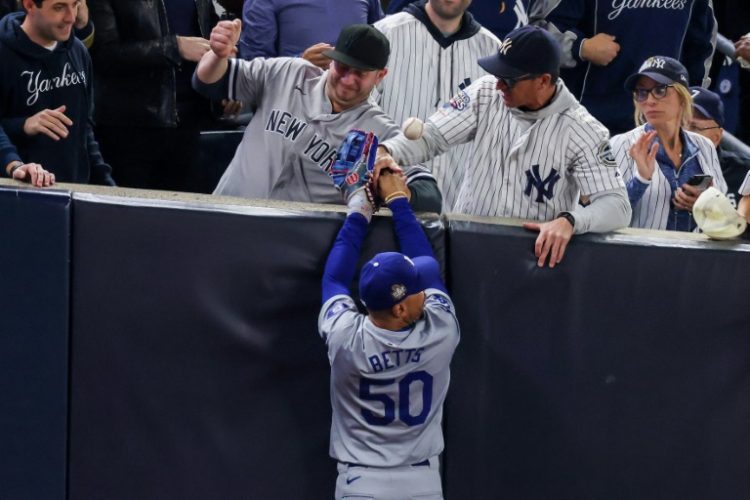 Two New York Yankees fans who interfered with Los Angeles Dodgers outfielder Mookie Betts as he tried to catch the ball for an out on Tuesday were banned from Wednesday's fifth game of the World Series, the Yankees announced. ©AFP