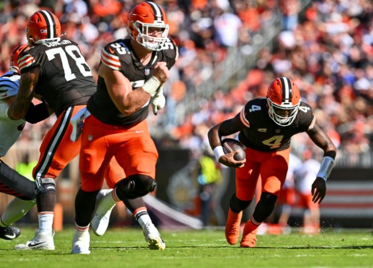 Cleveland quarterback Deshaun Watson, right, falls to the turf with what proved to be a season-ending ruptured Achilles tendon, the NFL team announced. ©AFP