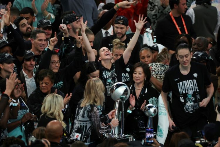 WNBA commissioner Cathy Engelbert, at center front presenting the championship trophy to the New York Liberty, will now enter talks on a new collective bargaining deal after the players union opted out of their current deal, which lasts through the 2025 season. ©AFP