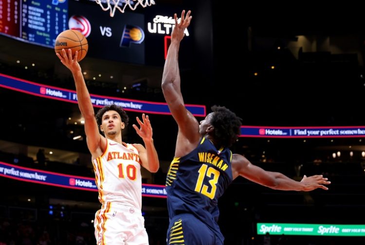 Indiana's James Wiseman, at right trying to defend Atlanta's Zaccharie Risacher, has torn his left Achilles tendon and will be out indefinitely, the NBA Pacers announced. ©AFP