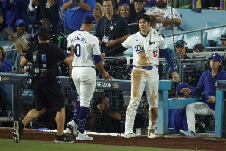 Los Angeles Dodgers pitcher Jack Flaherty is congratulted by teammate Shohei Ohtani after pitching seven scoreless innings against the New York Mets in game one of baseball's National League Championship Series. ©AFP